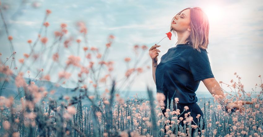 Woman in a Field Enjoying the Benefits of EFT Tapping / Emotional Freedom